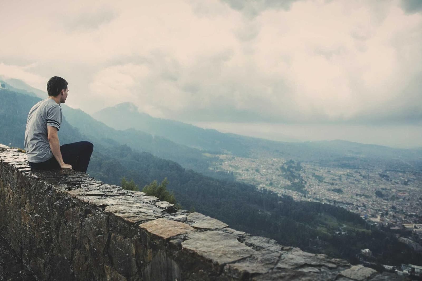 A person sitting high above a city, looking out.