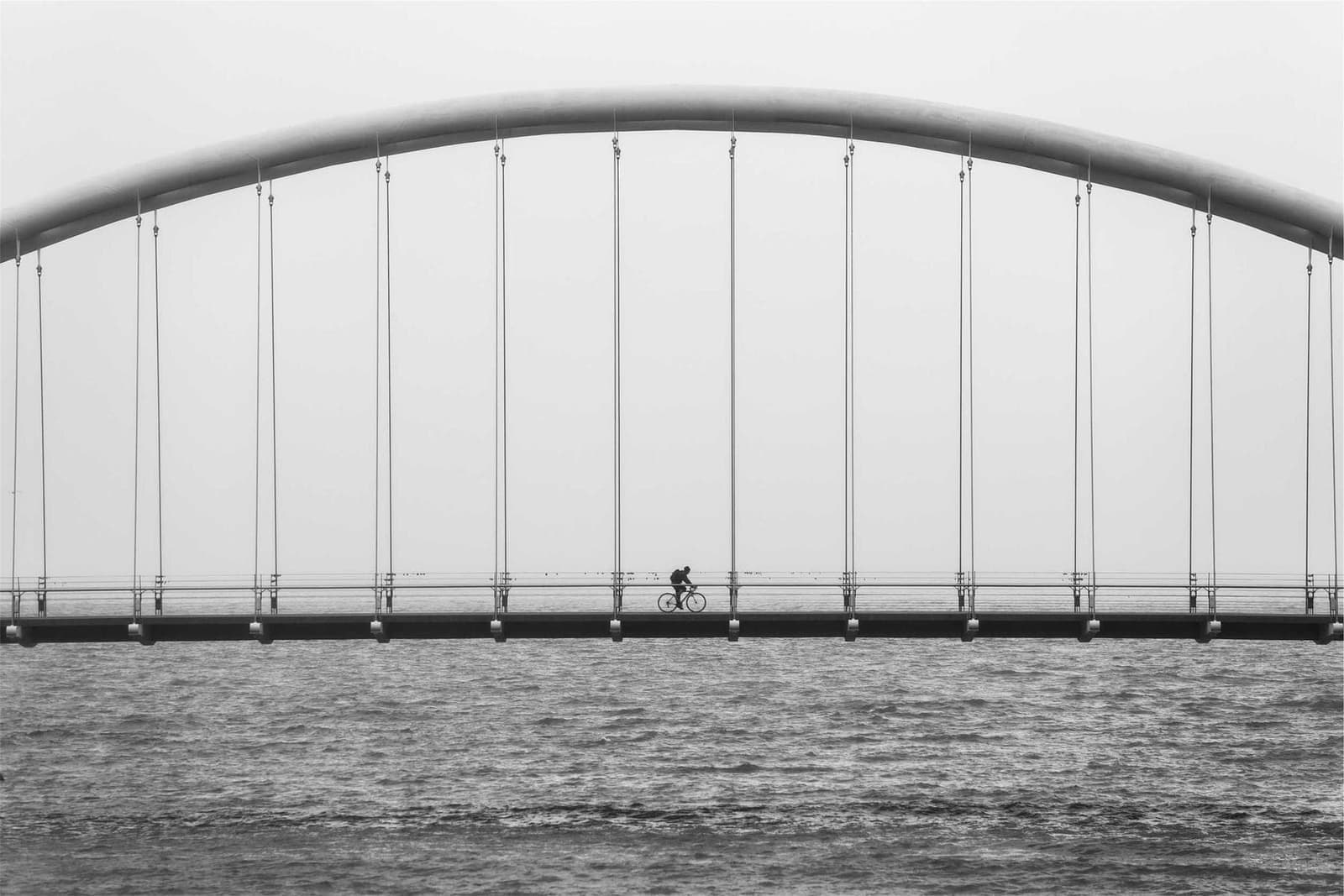 An arched bridge, in black and white.