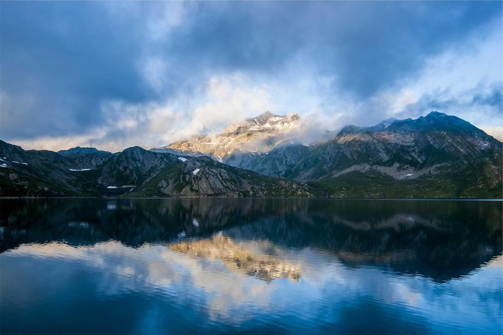 Mountains reflected in a still lake.